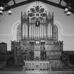 Interior.
View of Communion table and pulpit with organ behind from W.