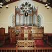 Interior.
View of Communion table and pulpit with organ behind from W.