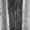 Detail of fragment of medieval graveslab bearing incised outline of a sword with depressed quillons, held in store at Langholm.