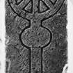 Detail of fragment of medieval graveslab bearing incised outline of a ringed cross, held in store at Langholm.