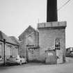 View from NW of steam engine houses, the beam engine house on the right having a cast iron roof tank made by G. Graham of Carlisle.  Also visible is the base of the boilerhouse chimney.