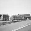 Distant view of the mill from SE, with Edinburgh Woollen Mills trailers in the foreground.