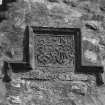 Detail of monumental plaque of 1665 on exterior of S gable.