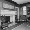 Interior, principal floor, front hall, view of fireplace and window at North West corner.