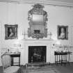 Interior, 1st. floor, white bedroom, view of fireplace with ornate mirror above.