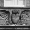 Courtyard, detail of coat of arms above central arched window on north wall