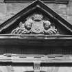Courtyard, detail of pediment above arched window on north wall