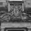 Courtyard, detail of pediment above doorway in centre of south wall