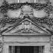 North facade, detail of tympanum with swag decoration over main entrance.