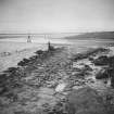 General view of paved way down foreshore at low tide.