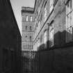 View from SE of gateway into courtyard adjoining SW elevation of mill block.