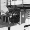 Detail of lamp at centre of level crossing gates (one on each of the two pairs of gates).