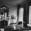 Cumstoun House, interior.
General view of drawing room, showing fireplace with elaborate overmantle mirror and bay windows.
