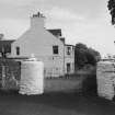 View of farmhouse and gatepiers from SW