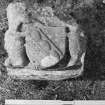 Detail of masonry fragment with carved heraldic device.