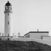 View from SW of lighthouse compound, showing outer wall, main gate, tower, and fog-horn engine house block (right).