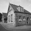 Oblique view from E along external frontage of station offices