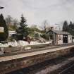 View from SW of N-bound platform, including waiting room and shelter, and station garden