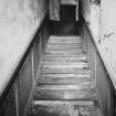 Ground floor interior, view of staircase prior to restoration