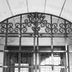 Museum block, entrance porch, detail of ornamental iron-work above gate