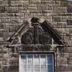 Museum block, west gable, detail of carved panel above window