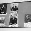 Entrance passageway, wall, board containing recognition photographs of senior officers, detail