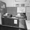 Upper level, North East corner, communications centre, desk with computer equipment on top, detail