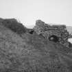 View of kiln from SSE, showing one of three draw arches, and brick vaulted passage beneath ramp (left)