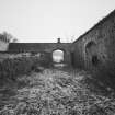 View from North West showing pend to carriage house block.  
Photosurvey 10 February 1994 at Kilrie Farm