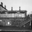 View across down platform to station buildings from E.