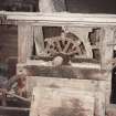 Detail of threshing machine (with side cover removed) showing threshing drum, concave ajusting levers and straw walkers, photographed 9 May 1994