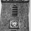 Steeple, upper portion, view from north showing clock and 1728 datestone