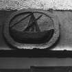 Panel on lintel - boat (painted) over pend. 
[Note: inscribed 'A' and 'E' on surround]