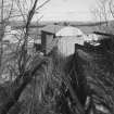 View from S along path of rope-hauled tramway (from limestone mine) towards former winding-engine house, with tops of former shaft kilns just visible in background