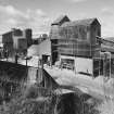 General view from SE of W end of lime works, which includes limestone milling departments containing ball mills, hopper stores, grading, bagging and conveying equipment