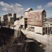 General view from SE of W end of lime works, which includes limestone milling departments containing ball mills, hopper stores, grading, bagging and conveying equipment