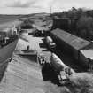 Elevated view from W (at middle level of shaft kilns) of E end of site, including workshops and offices, with old lime kiln (distant right, NO30NE 23.3)