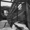 View from N at middle level of shaft kilns, showing the conveyor taking crushed limestone from the crusher into the former kilns for storage