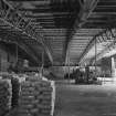 Interior view from SW across lime store (a former aircraft hangar), revealing its latticed steel frame