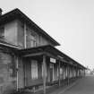 Detailed view from S along N-bound platform showing awning in front of station offices