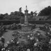 Walled garden, rose garden, sundial capped by small figure, view from SE