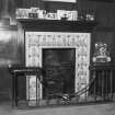 Interior. Detail of fireplace in entrance hall with blue and white figurative tiles