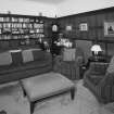 Interior. View of ground floor TV room original dining room from NE showing bookcases