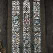Interior. Detail of stained glass window in S wall