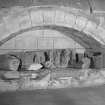 Interior. Collection of carved stone fragments in archway on S wall of ante-chapel