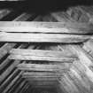 Detail of roof structure including carpenters' assembly marks on rafters and collars.