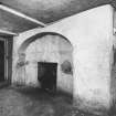 Detail of fireplace on North wall of kitchen in North apartment on ground floor.