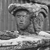 General view of multi-faced carved stone head on top of wall, originally from King Edward Castle.