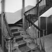 Interior. View of half turn with landings staircase at ground floor level showing fluted newel posts and turned balusters