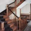 Interior. View of half turn with landings staircase at first floor level showing fluted newel posts and turned balusters